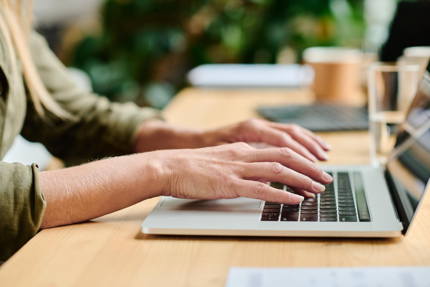 Hands on a laptop